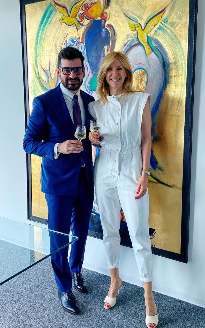 Tudor Coltan with Doer founder — editorial photograph in front of colorful artwork